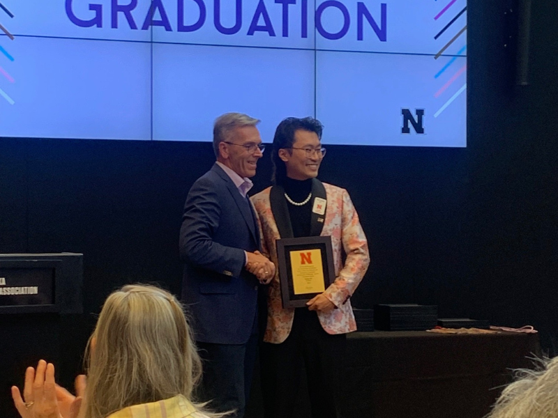 Nathan Hé is presented the Chancellor’s Award for Outstanding Contributions to the GLBT Community by Chancellor Ronnie Green on May 4, 2023. 
